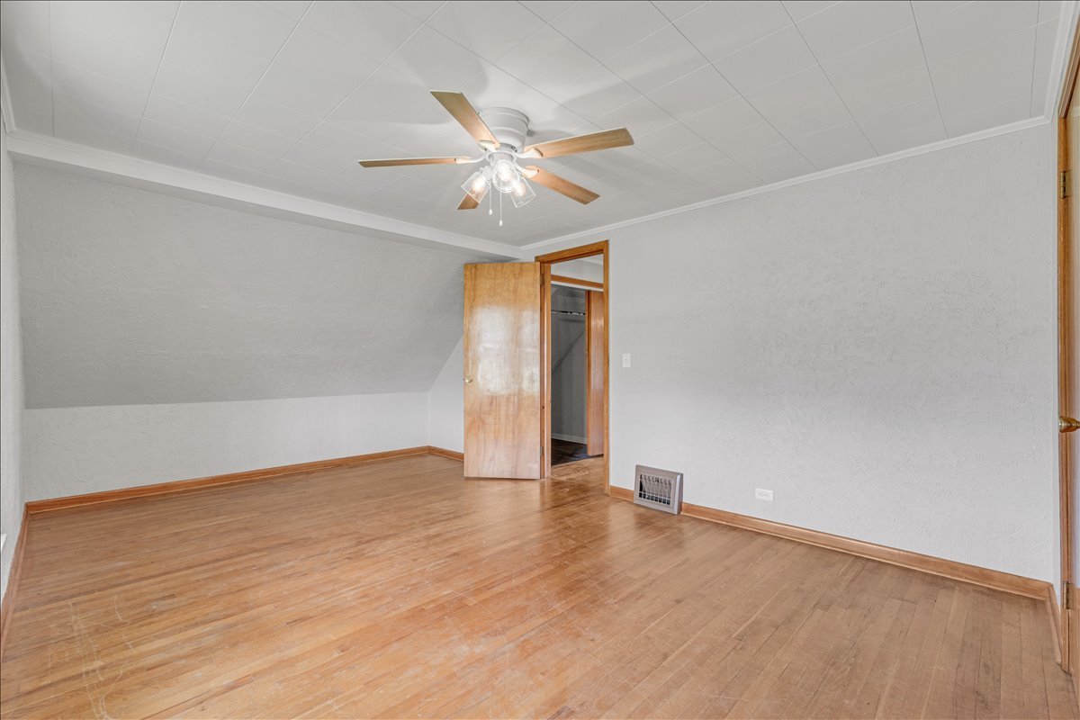 8850 Ridgewood Road Rock Island, IL 61201 - Photo 31 of 45 an empty room with wooden floor fan and windows