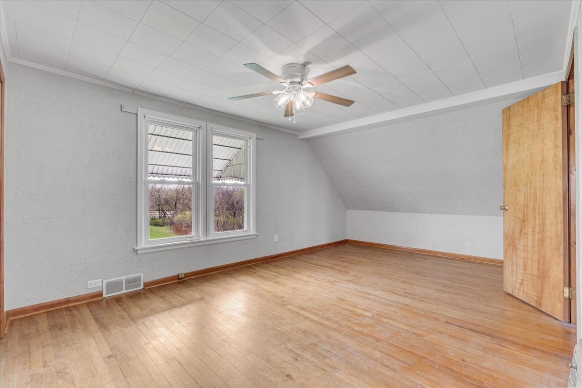 8850 Ridgewood Road Rock Island, IL 61201 - Photo 32 of 45 an empty room with wooden floor and windows