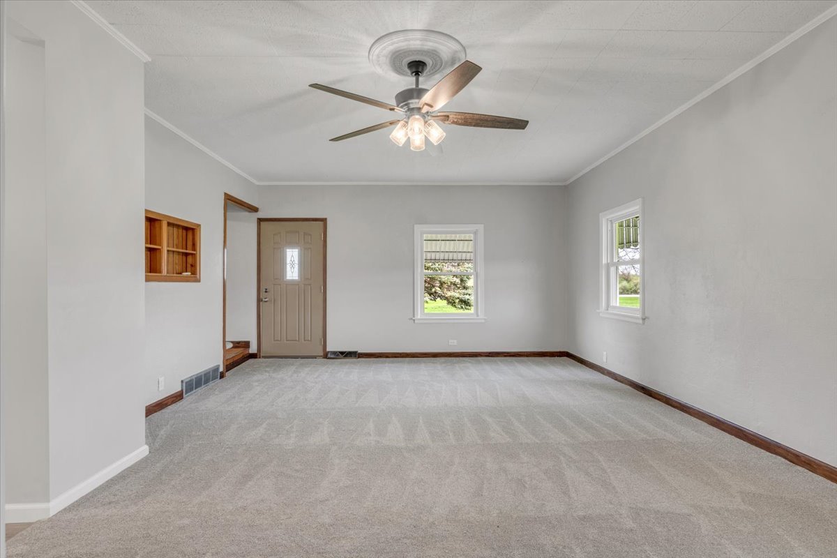 8850 Ridgewood Road Rock Island, IL 61201 - Photo 9 of 45 an empty room with windows and ceiling fan