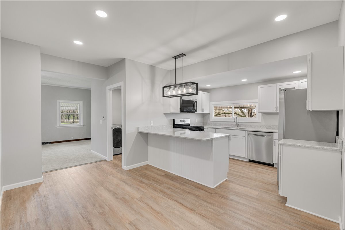 8850 Ridgewood Road Rock Island, IL 61201 - Photo 10 of 45 a kitchen with white cabinets and appliances
