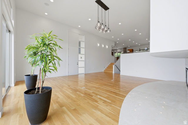 1389 Millbrook Way Bountiful, UT 84010 - Photo 18 of 74 Expansive living space featuring light wood-finish flooring, recessed ceiling lights, and abundant natural light from large sliding glass doors