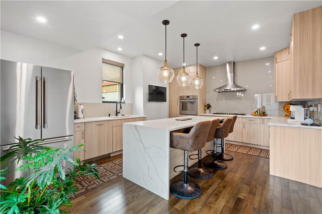 1520 4th Avenue Coraopolis, PA 15108 - Photo 9 of 37 Large chef’s kitchen (over 250 SF) equipped with new Thermador stainless steel appliances; microwave drawer built into island that measures 38” x 94” (waterfall finish); stone countertops; custom-made glass backsplash; recessed LED lights and pendant lights (all dimmable); soft-close cabinetry with roll-out shelves and lazy Susan.