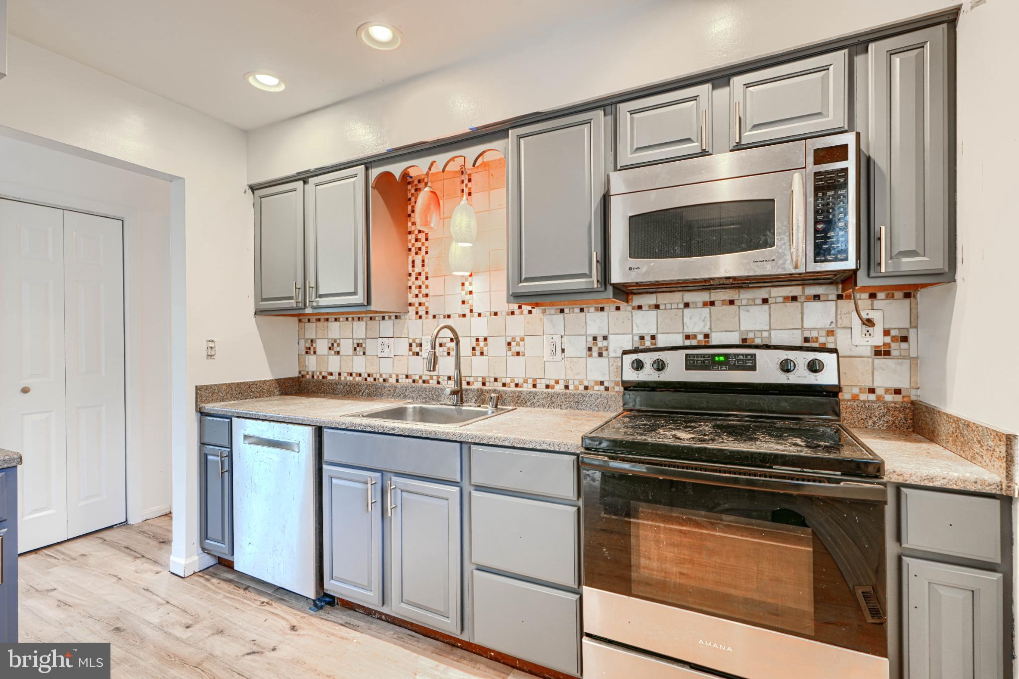 1167 Long Valley Road Westminster, MD 21158 - Photo 13 of 36 a kitchen with stainless steel appliances a stove sink and microwave