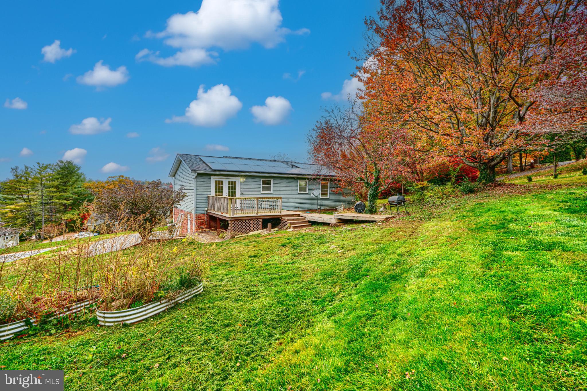 1167 Long Valley Road Westminster, MD 21158 - Photo 35 of 36 a backyard of a house with a garden and barbeque oven