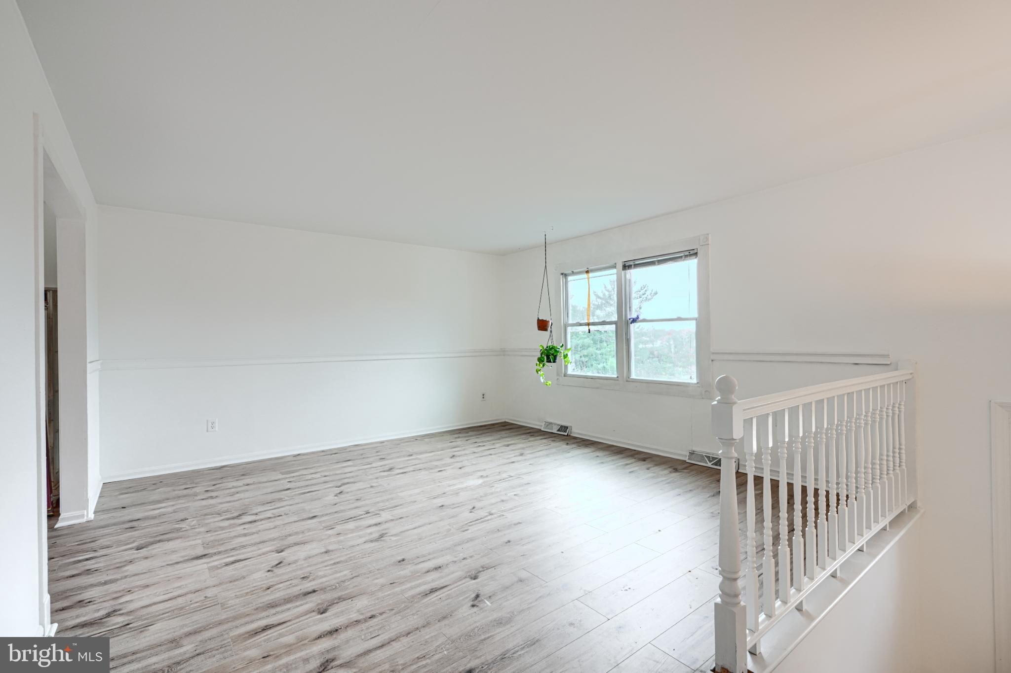 1167 Long Valley Road Westminster, MD 21158 - Photo 5 of 36 a view of an empty room with wooden floor and a window
