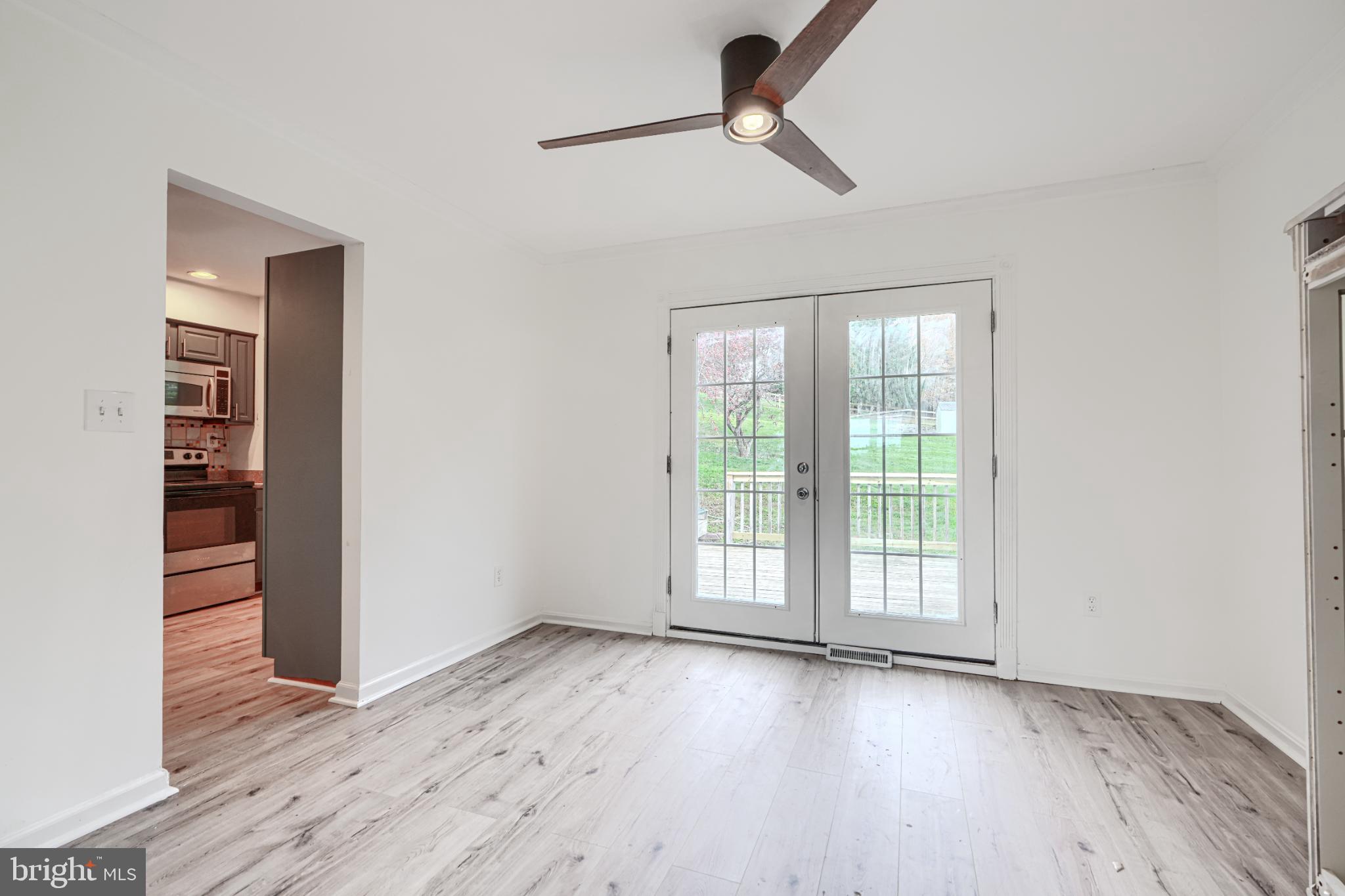 1167 Long Valley Road Westminster, MD 21158 - Photo 9 of 36 an empty room with wooden floor fan and windows