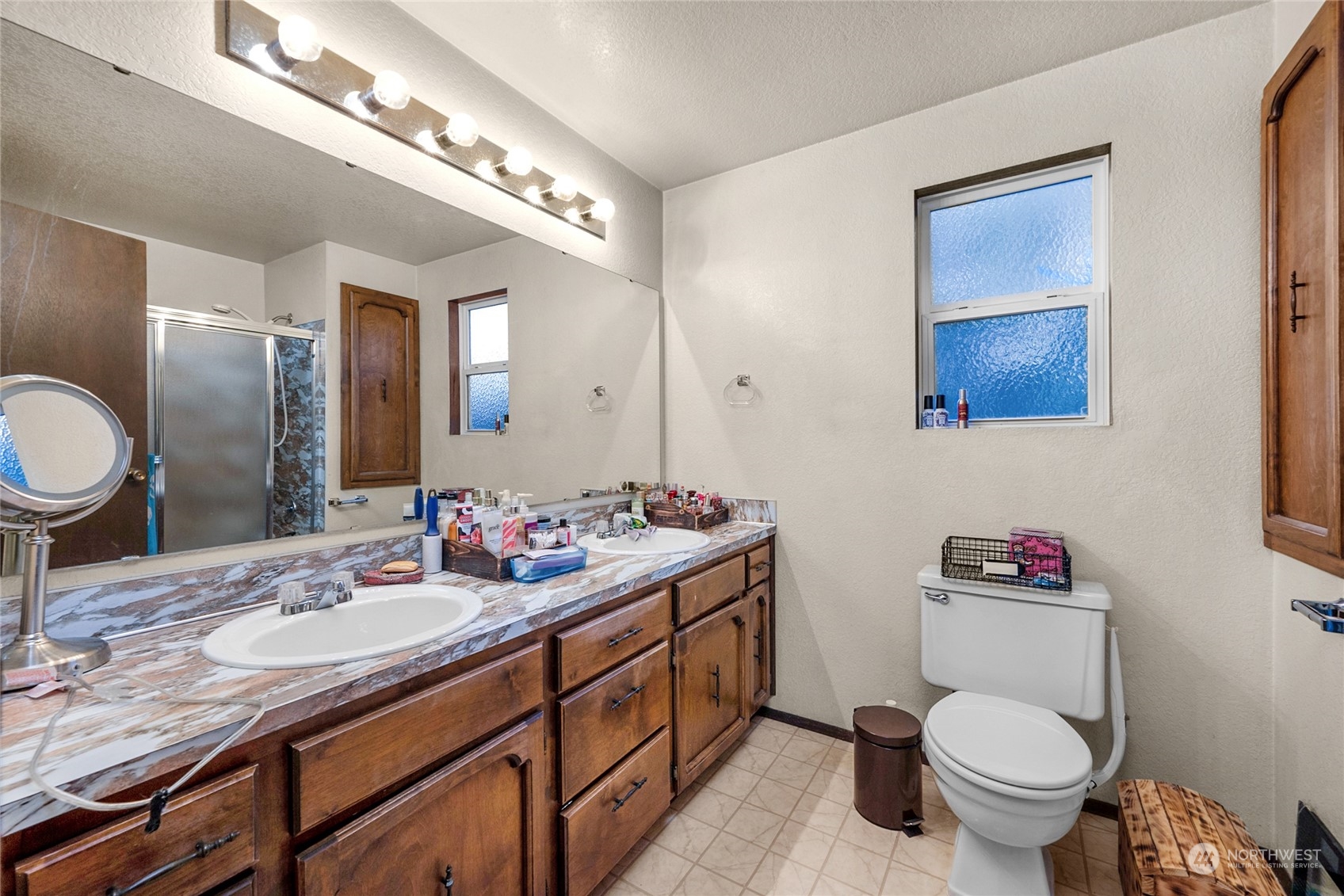 19930 13th Drive Southeast Bothell, WA 98012 - Photo 11 of 22 a bathroom with a toilet a sink and a mirror