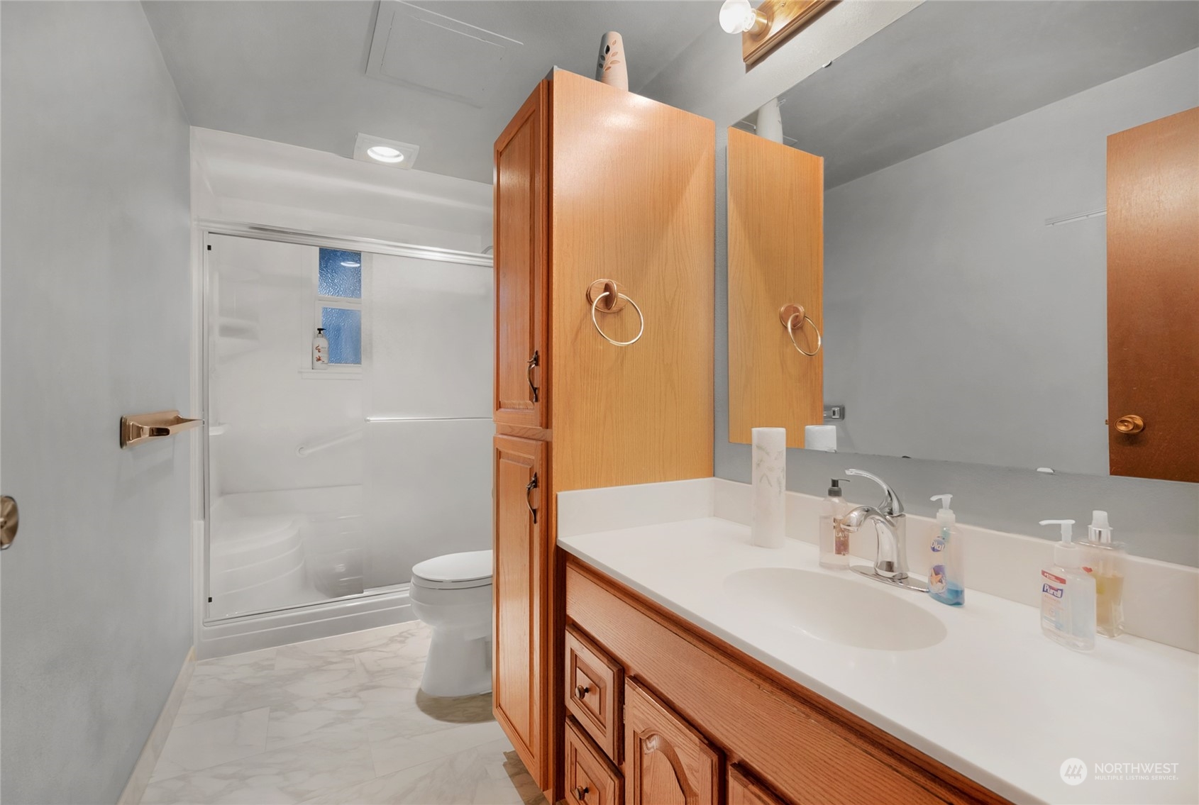 19930 13th Drive Southeast Bothell, WA 98012 - Photo 14 of 22 a bathroom with a sink a toilet and shower