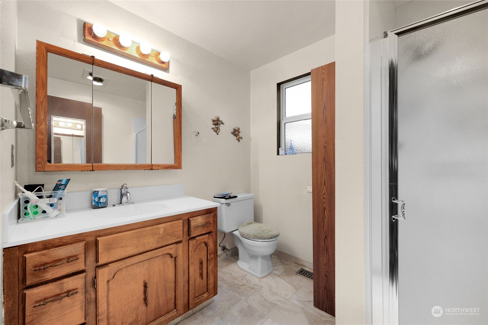 19930 13th Drive Southeast Bothell, WA 98012 - Photo 10 of 22 a bathroom with a toilet sink and mirror