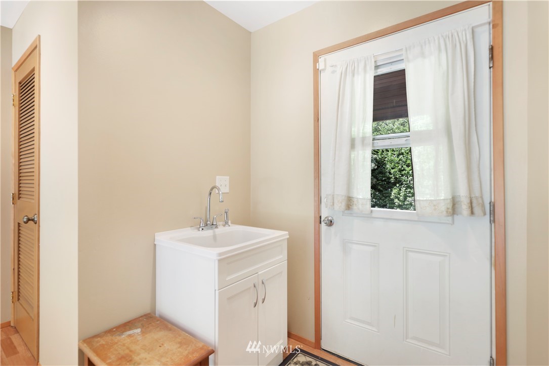 50332 Concrete Sauk Valley Road Concrete, WA 98237 - Photo 17 of 40 a bathroom with a sink a mirror and a window