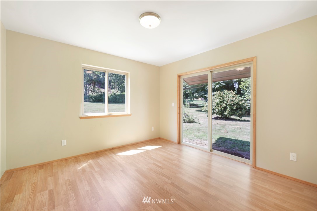 50332 Concrete Sauk Valley Road Concrete, WA 98237 - Photo 18 of 40 a view of an empty room with wooden floor and a window