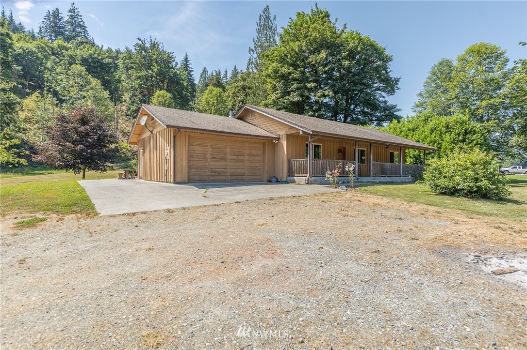 50332 Concrete Sauk Valley Road Concrete, WA 98237 - Photo 29 of 40 front view of a house with a yard and trees