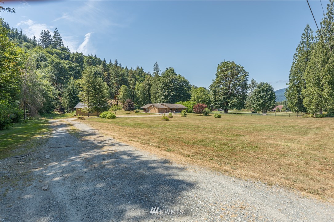 50332 Concrete Sauk Valley Road Concrete, WA 98237 - Photo 33 of 40 a view of a field with trees in the background
