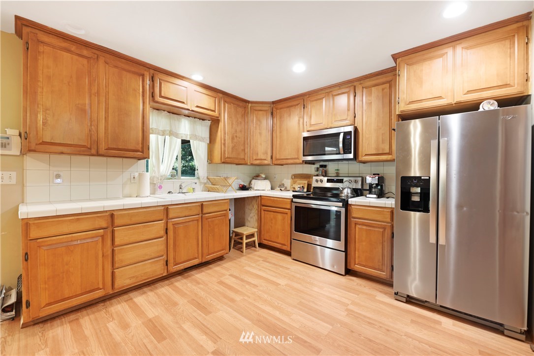 50332 Concrete Sauk Valley Road Concrete, WA 98237 - Photo 9 of 40 a kitchen with granite countertop a refrigerator stove top oven a sink and dishwasher
