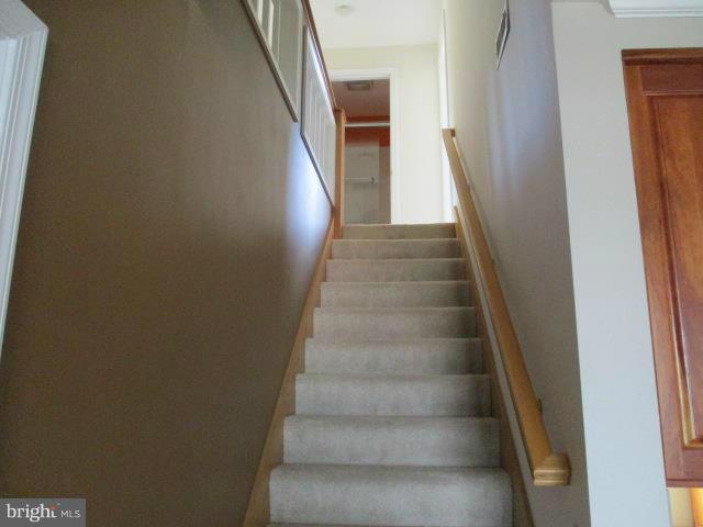2919 Ritchie Avenue Baltimore, MD 21219 - Photo 16 of 24 a view of staircase with white walls and white door