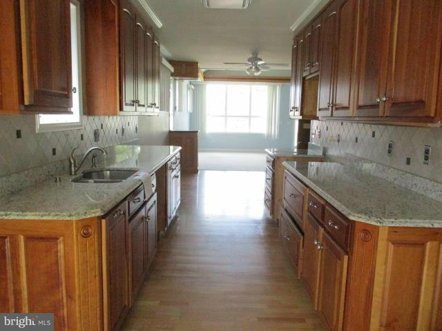 2919 Ritchie Avenue Baltimore, MD 21219 - Photo 7 of 24 a kitchen with granite countertop a sink a counter space and cabinets