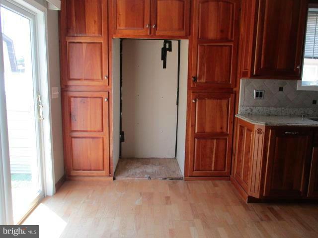 2919 Ritchie Avenue Baltimore, MD 21219 - Photo 9 of 24 an empty room with wooden floor and cabinet