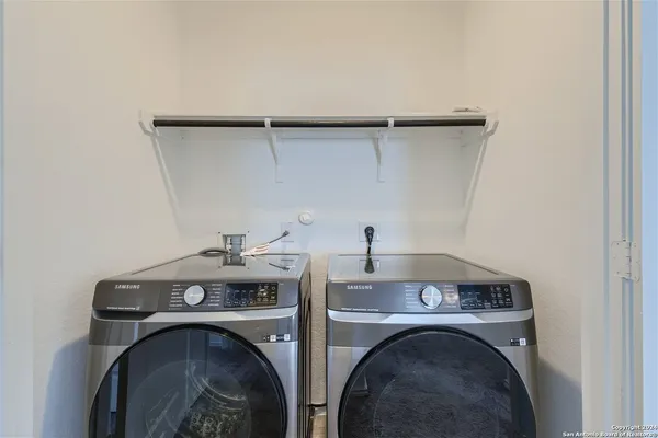 a metallic refrigerator freezer sitting in a kitchen