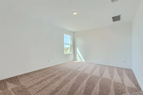 a bathroom with a granite countertop sink a toilet and a mirror