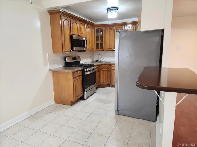 a kitchen with stainless steel appliances granite countertop a refrigerator stove and sink