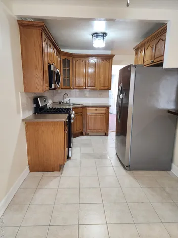 a kitchen with stainless steel appliances granite countertop a refrigerator and a stove