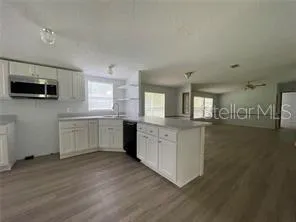 a kitchen with a sink and a stove top oven