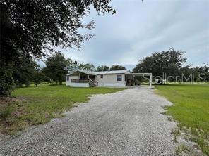 5416 Miley Road Plant City, FL 33565 - Photo 3 of 19 a front view of a house with a yard