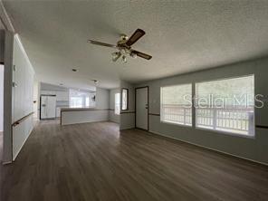 5416 Miley Road Plant City, FL 33565 - Photo 6 of 19 a view of empty room with wooden floor and fan