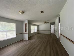 5416 Miley Road Plant City, FL 33565 - Photo 7 of 19 a view of empty room with wooden floor and fan