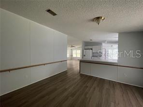 5416 Miley Road Plant City, FL 33565 - Photo 8 of 19 a hallway with stairs and wooden floor