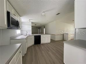 5416 Miley Road Plant City, FL 33565 - Photo 10 of 19 a kitchen with stainless steel appliances wooden cabinets and a granite counter tops