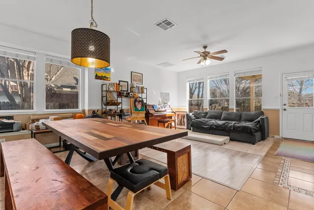 a living room with furniture a chandelier and a table