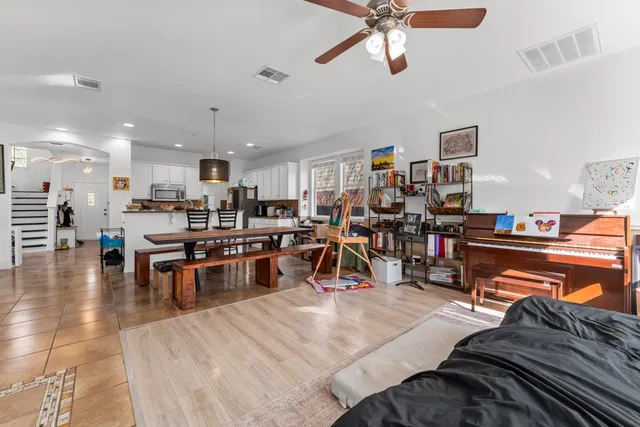 a living room with lots of furniture and kitchen view