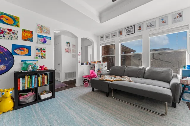 a living room with furniture and a book shelf