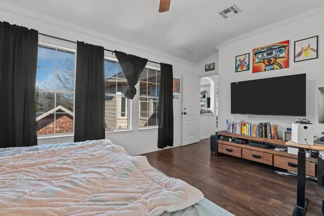 a bedroom with furniture and flat screen tv