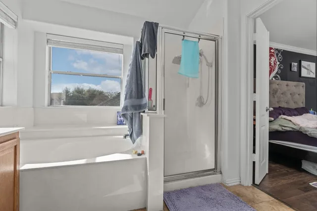 a bathroom with a bathtub and a shower