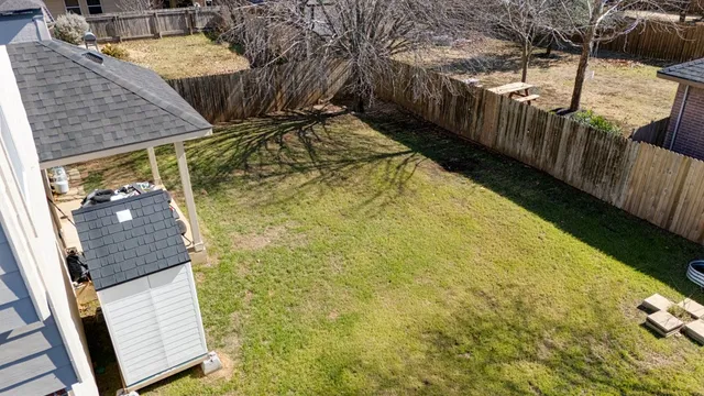 a backyard of a house with wooden fence