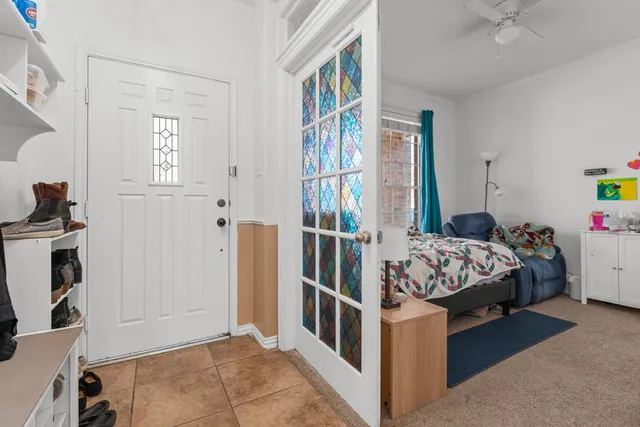 a bedroom with bed and a window