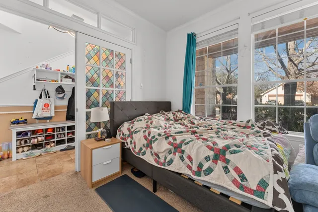 a bedroom with a bed and a window