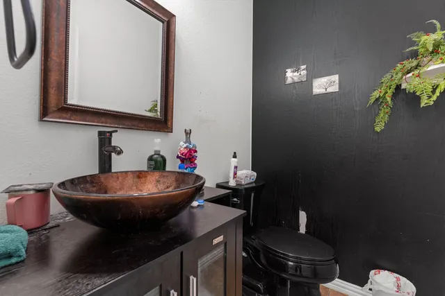 a bathroom with a sink a toilet and mirror