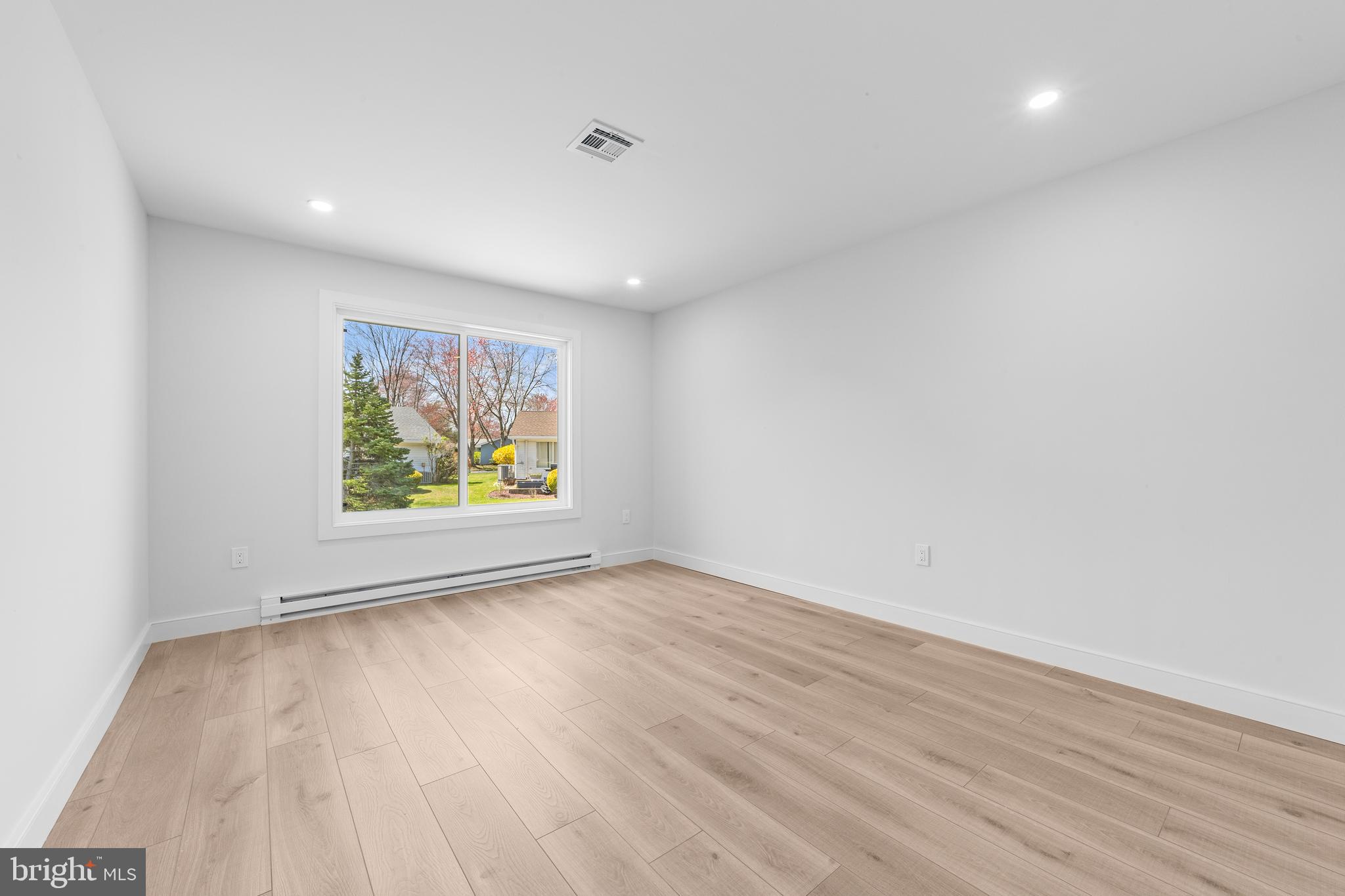 737A Prospect Road Monroe Township, NJ 08831 - Photo 16 of 28 a view of an empty room with wooden floor and a window