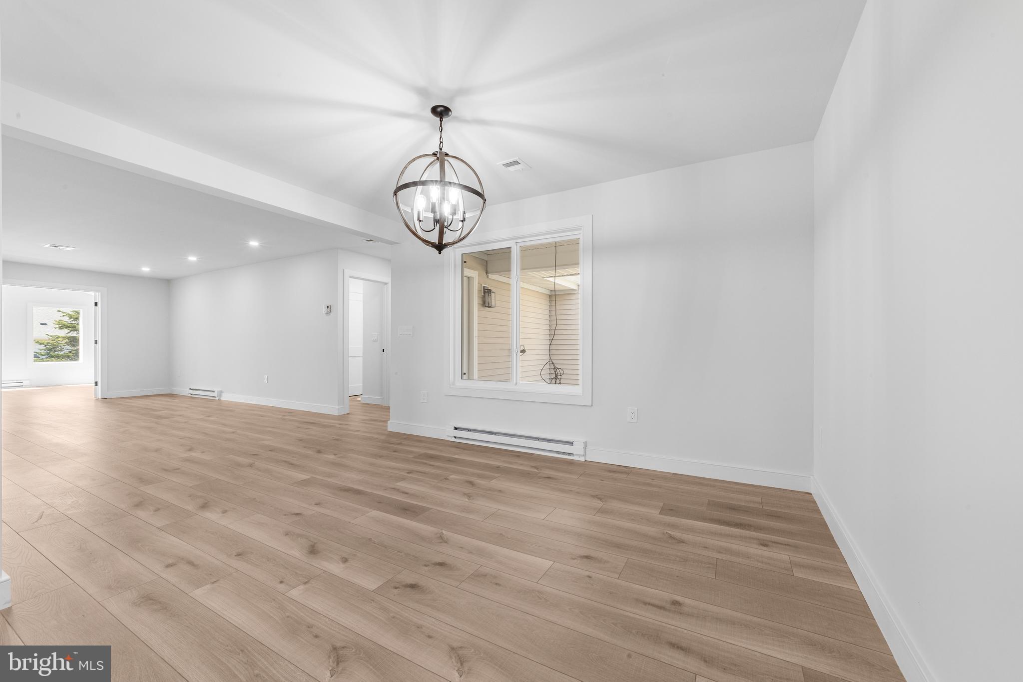 737A Prospect Road Monroe Township, NJ 08831 - Photo 7 of 28 a view of empty room with wooden floor and chandelier