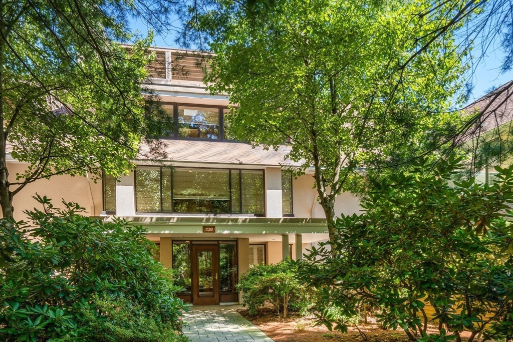 228 Allandale Road, Unit 1B Boston, MA 02467 - Photo 1 of 30 front view of a house with a yard