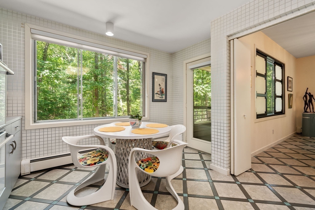 228 Allandale Road, Unit 1B Boston, MA 02467 - Photo 11 of 30 a view of a dining room with furniture window and outside view
