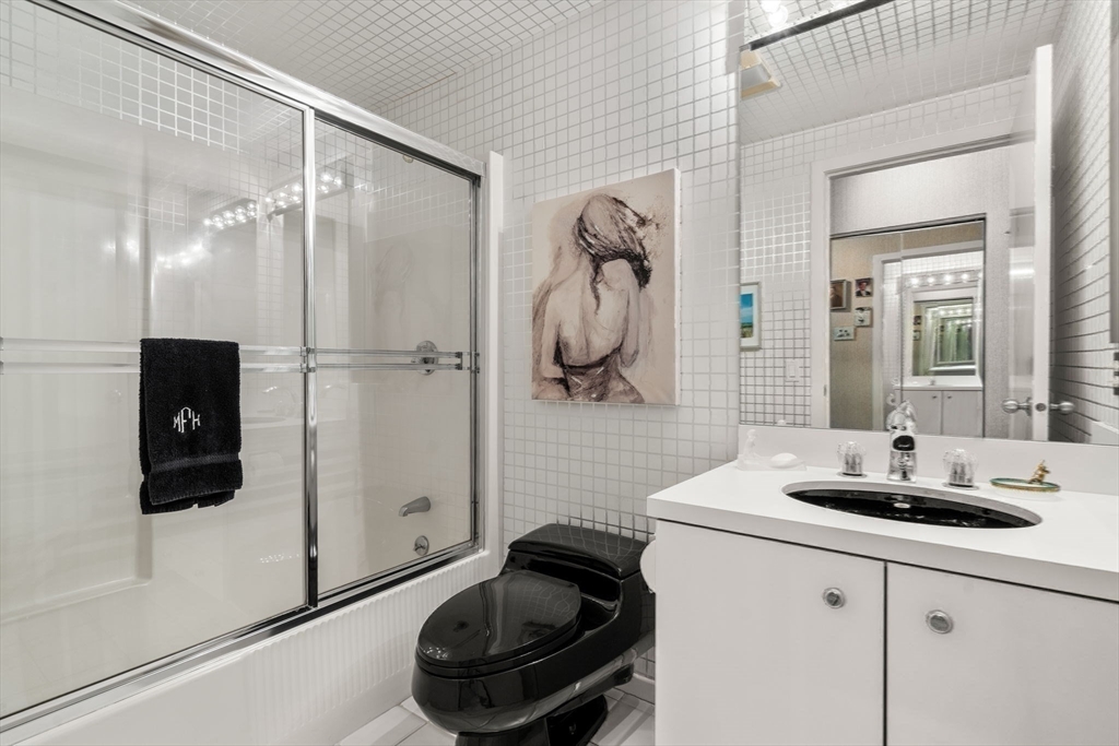 228 Allandale Road, Unit 1B Boston, MA 02467 - Photo 21 of 30 a bathroom with a sink and a mirror