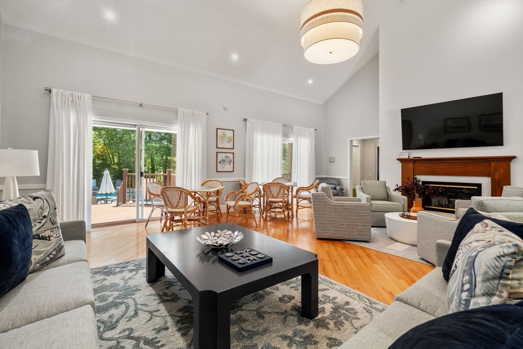 228 Allandale Road, Unit 1B Boston, MA 02467 - Photo 28 of 30 a living room with fireplace furniture and a flat screen tv