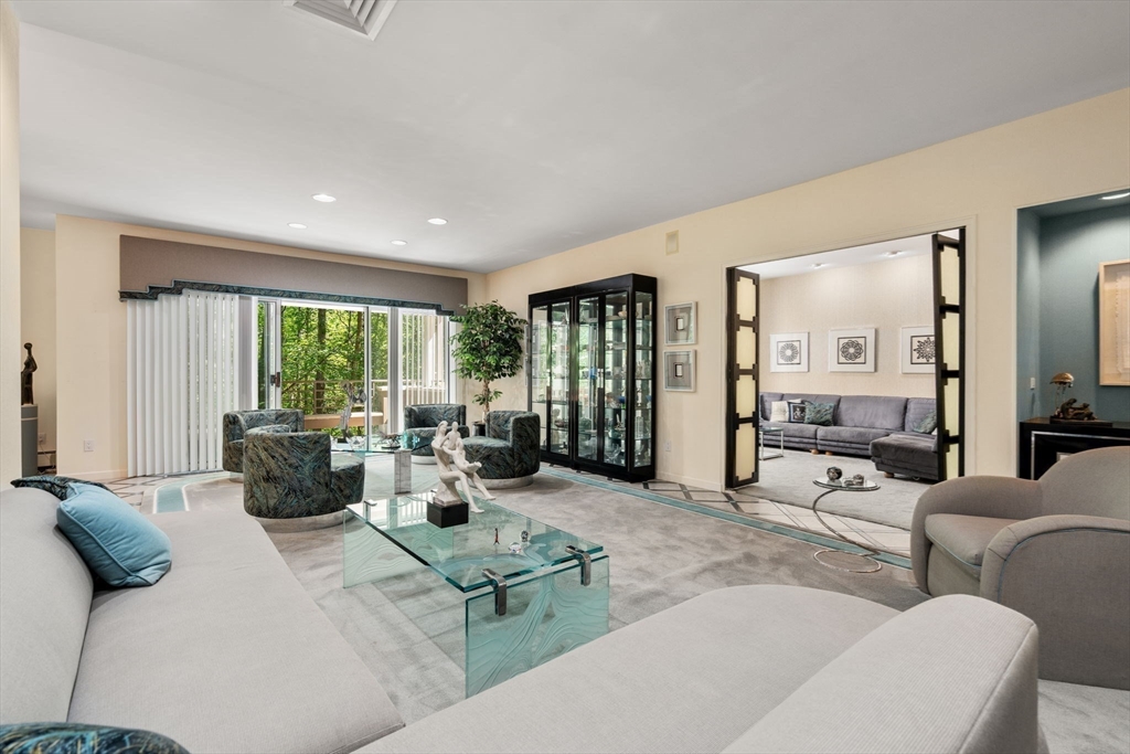 228 Allandale Road, Unit 1B Boston, MA 02467 - Photo 4 of 30 a living room with furniture and large windows