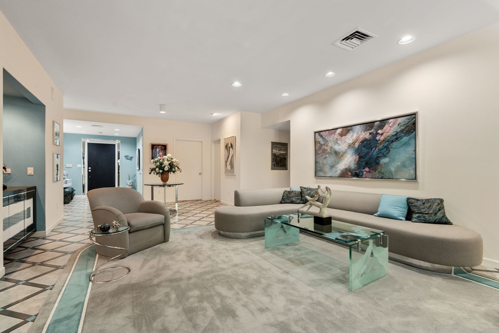 228 Allandale Road, Unit 1B Boston, MA 02467 - Photo 5 of 30 a living room with furniture and a flat screen tv