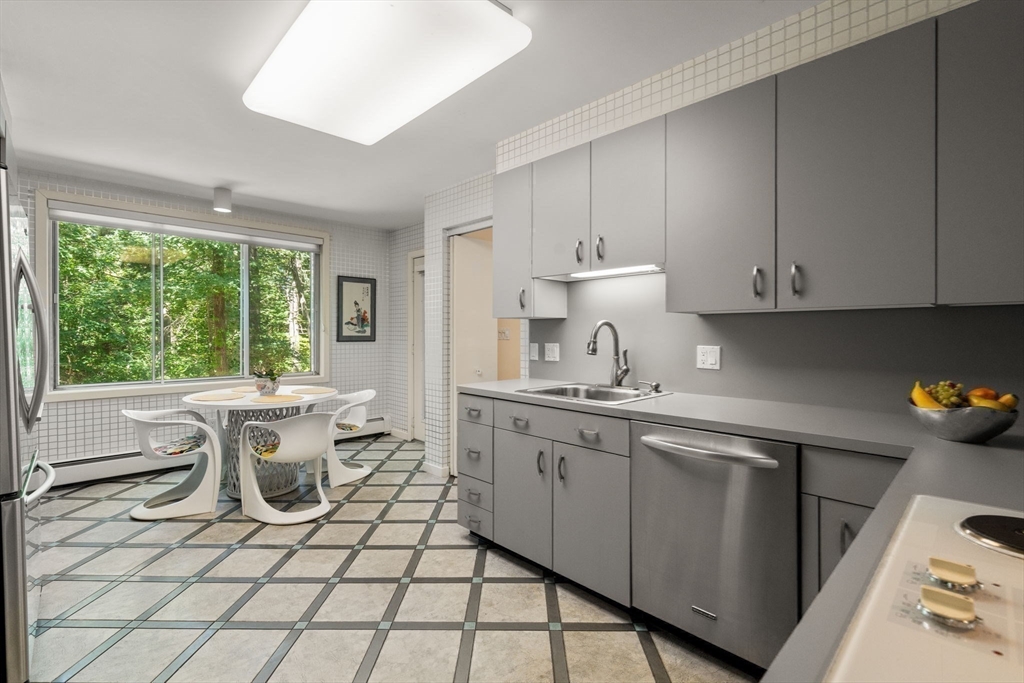 228 Allandale Road, Unit 1B Boston, MA 02467 - Photo 9 of 30 a kitchen with a sink cabinets and window
