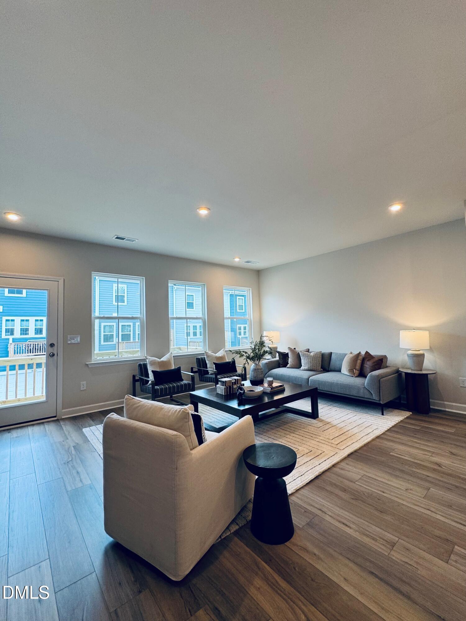 706 Hyperion Alley Wake Forest, NC 27587 - Photo 14 of 65 a living room with furniture wooden floor and windows